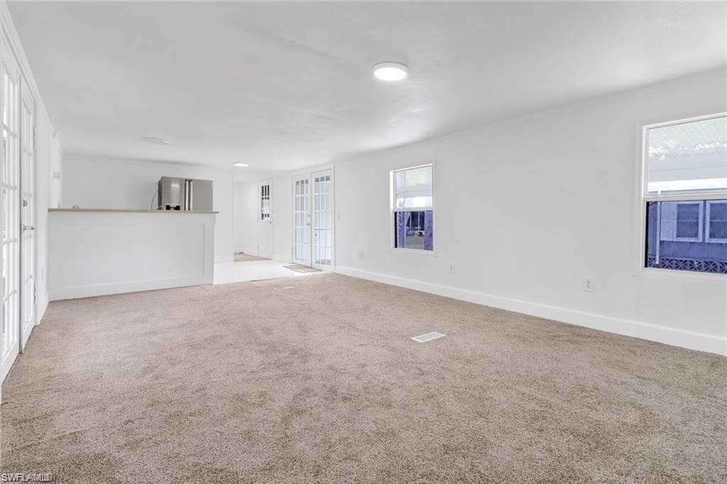 living room featuring carpet and baseboards