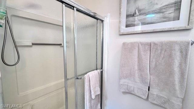 Shower with sliding glass doors and white fiberglass surround