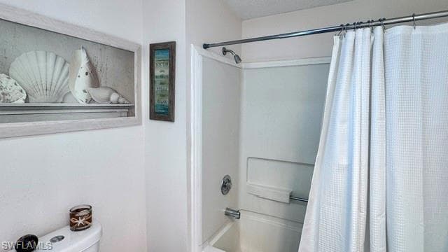 White fiberglass shower enclosure with a chrome shower head and faucet set