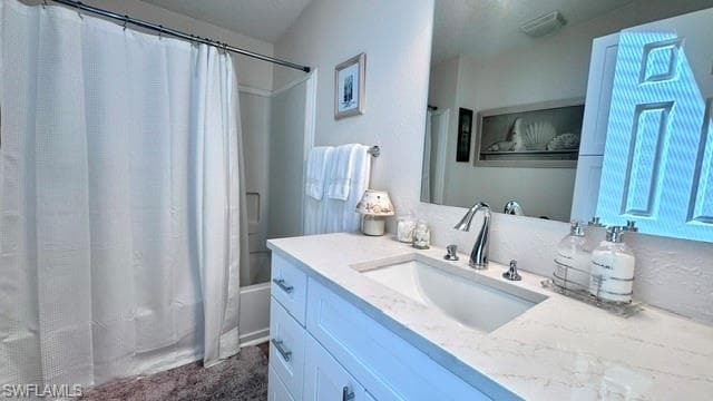 White shaker style vanity with brushed nickel hardware, integrated sink, and a light-toned countertop