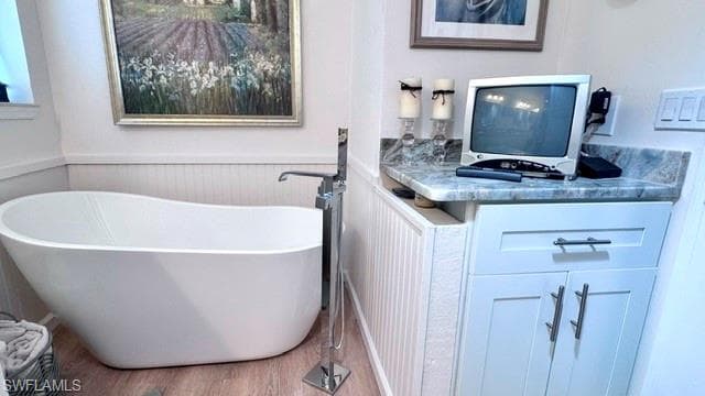 Freestanding soaking tub featuring a floor-mounted faucet
