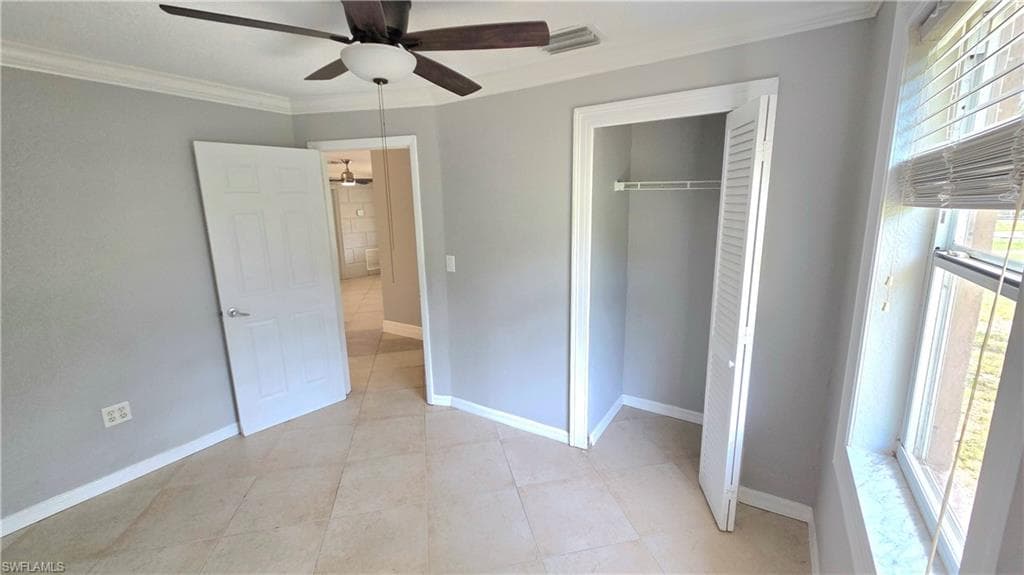 Bedroom #2 featuring tile flooring, a ceiling fan with light fixture, and a window with horizontal blinds