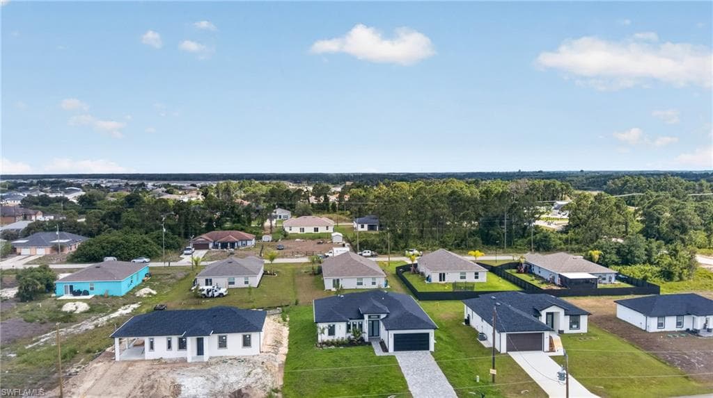 Recently constructed homes featuring modern architectural styles and dark-shingle roofs