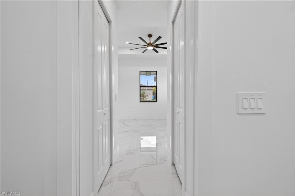 Hallway with white walls and a light switch panel