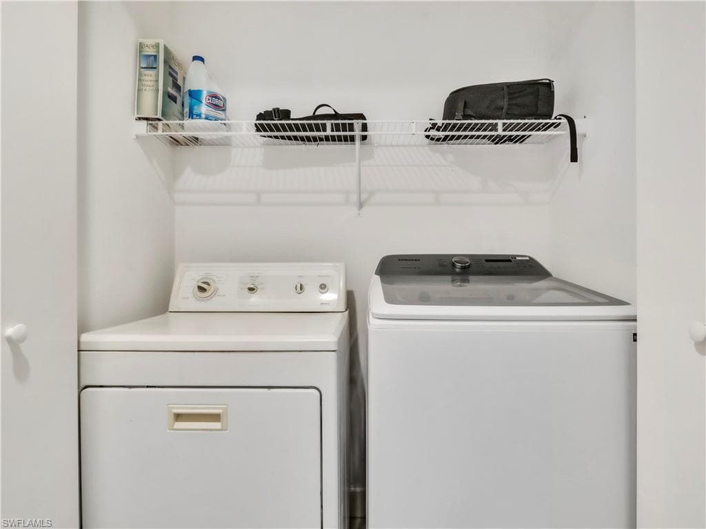 Laundry room with washing machine and clothes dryer