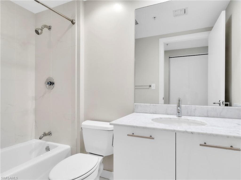 Bathroom with vanity and shower combination
