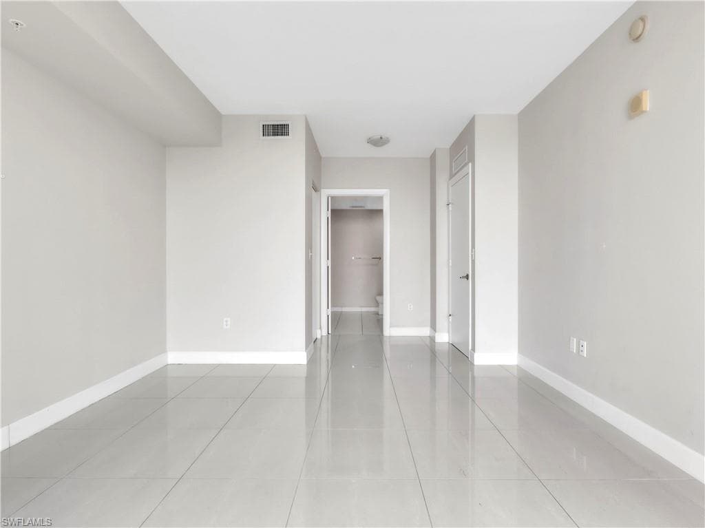 Empty room with light tile patterned floors
