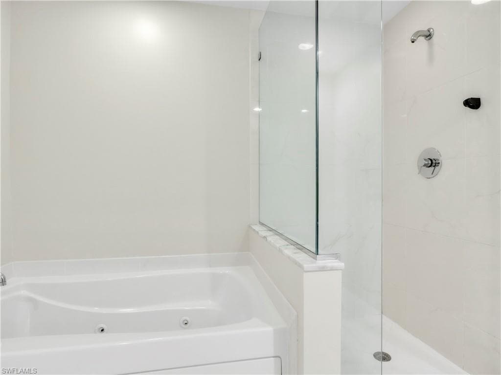 Full bath featuring a jetted tub and a walk in shower