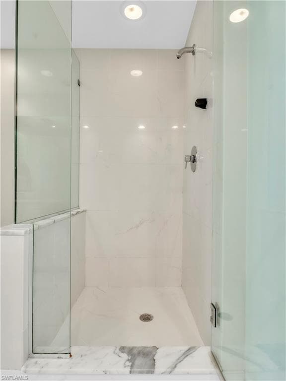 Full bath featuring a shower stall