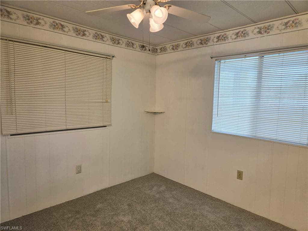 Bedroom #1 with NEW neutral carpet and ceiling fan.