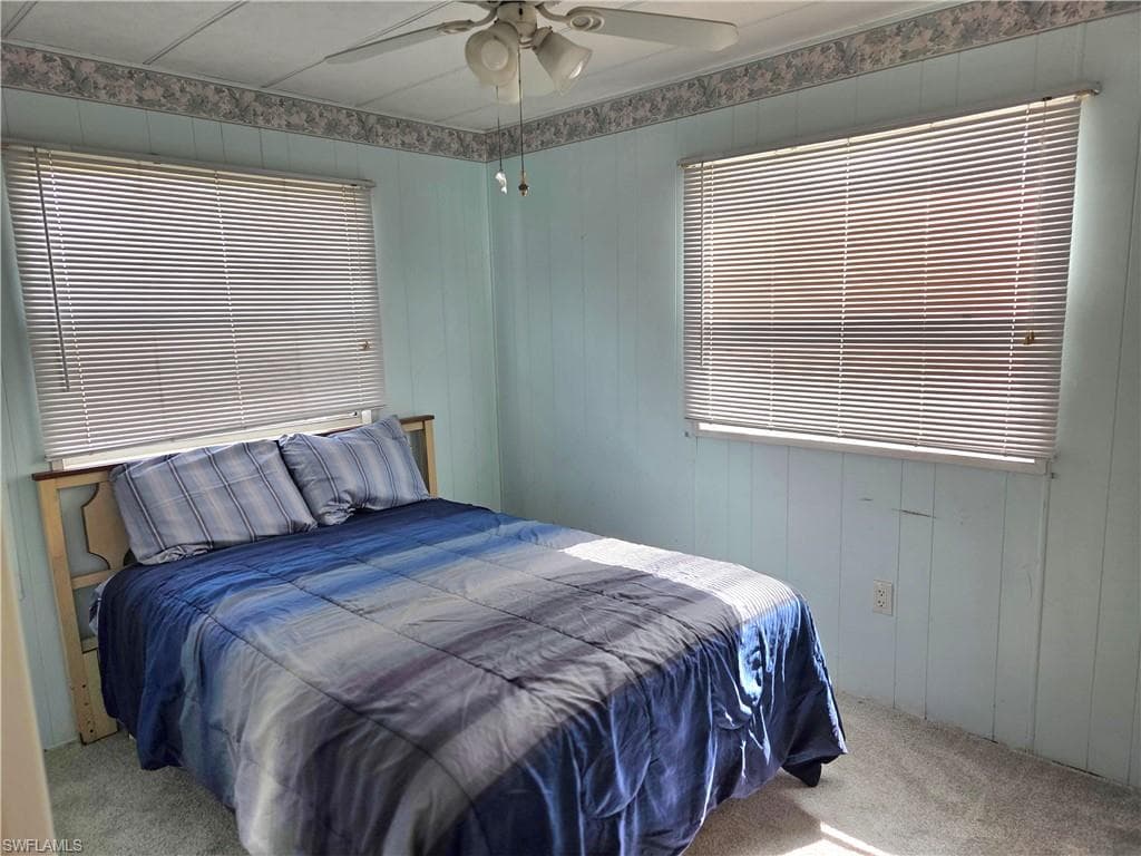 Bedroom #2 with ceiling fan and NEW neutral carpet.