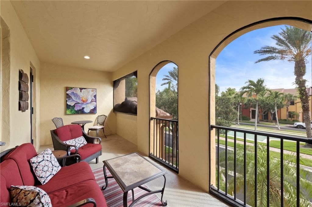 Screened lanai featuring arched openings, textured walls, recessed lighting, and a black metal railing. NEW NO-SEE-UM SCREEN (2025)