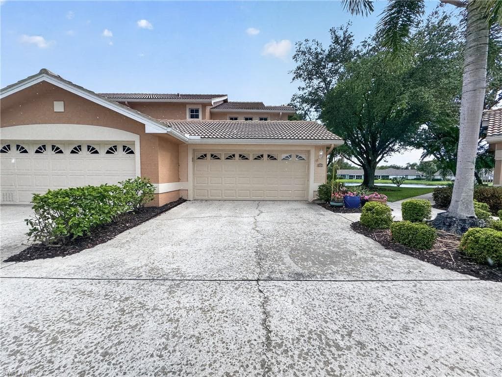 Driveway Entrance to Condo, 2 car Garage, automatic door opener. Garage has pull down stairway allowing easy access to extra storage.