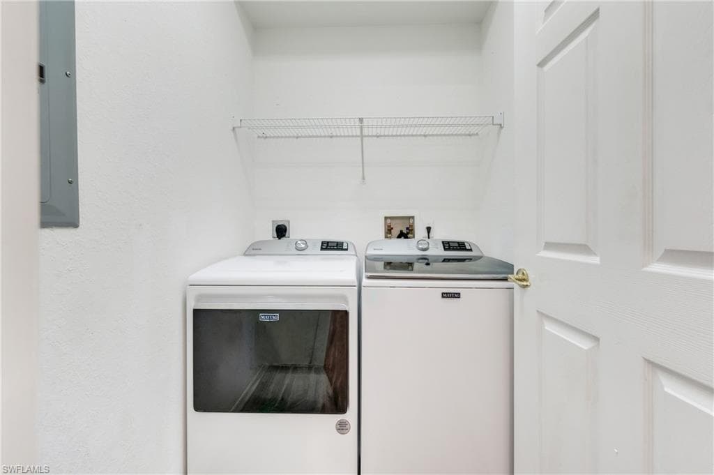 Dedicated laundry alcove with overhead shelving