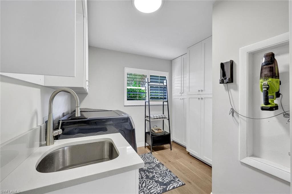 Good size Laundry Room with hanging space, sink, closet storage