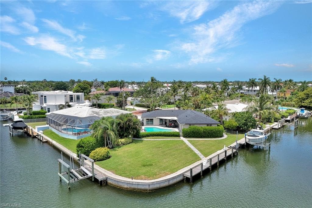 60' YACHT or Larger, 20,000# Lift, Jet Skis Lift -200' SEAWALL on .37 ACRE TIP LOT - 3 BOAT DOCKS Remodeled Cottage and New Construction ENGINEERED POLANS by Falcon Design!!!