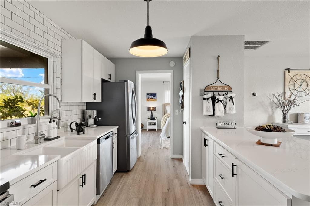 Double bowl farm sink with high-arc faucet on the left