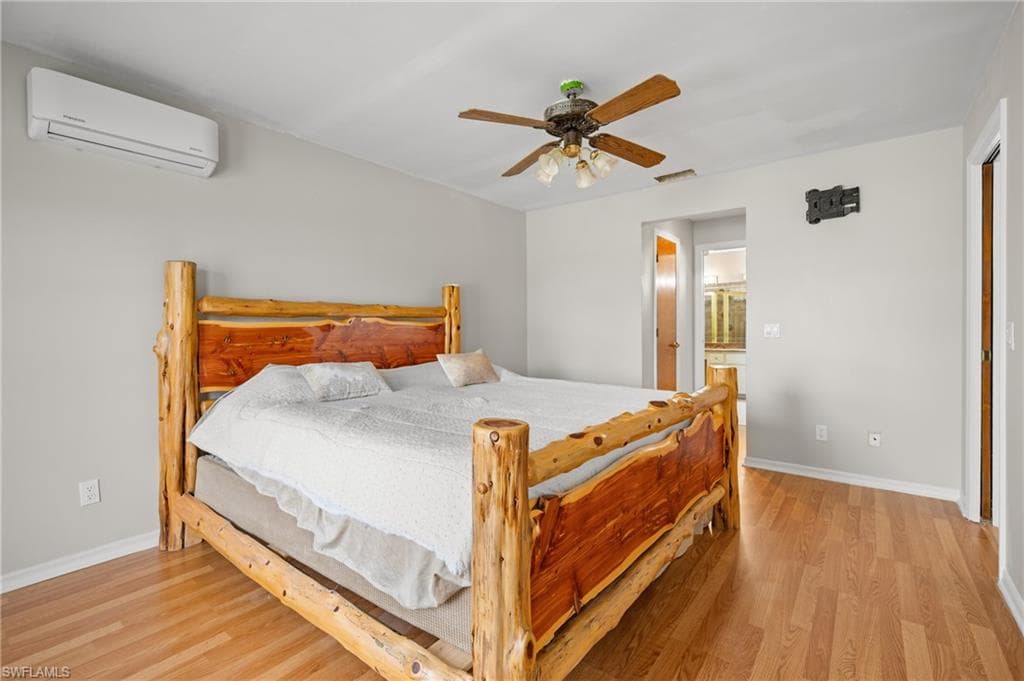 Warm wood-finish flooring complements light gray walls