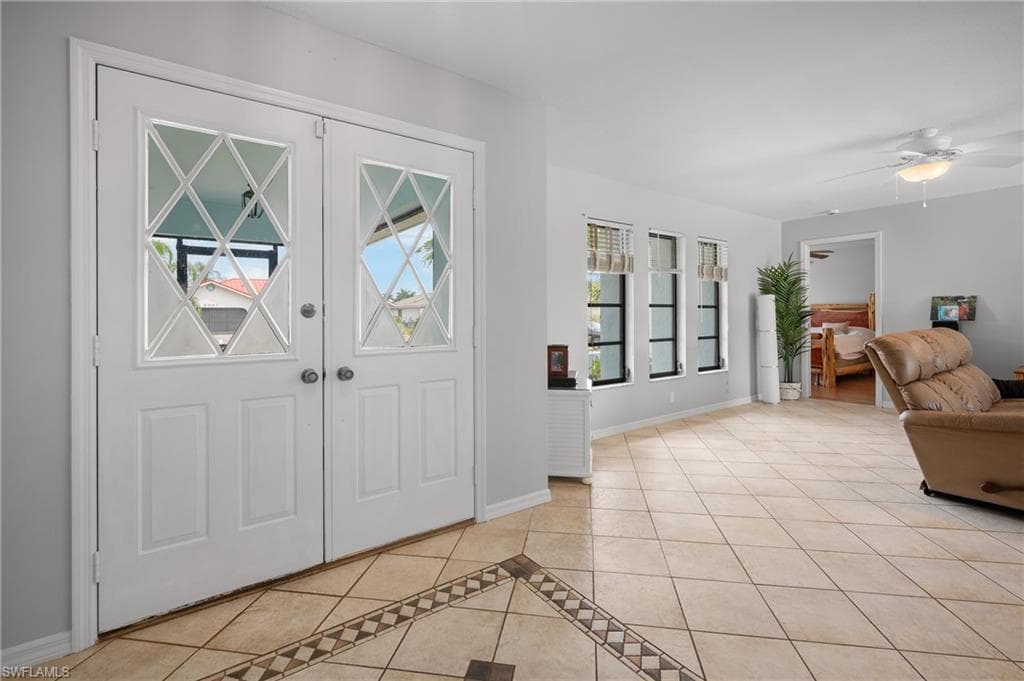 Entryway featuring double doors with decorative glass inserts