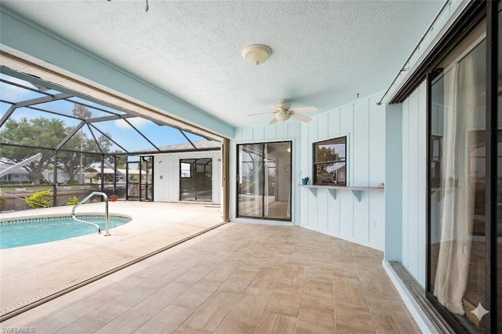 Spacious screened lanai with tile-finish flooring and ceiling fan