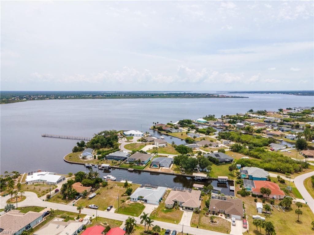 Aerial perspective showcasing waterfront properties with private boat docks