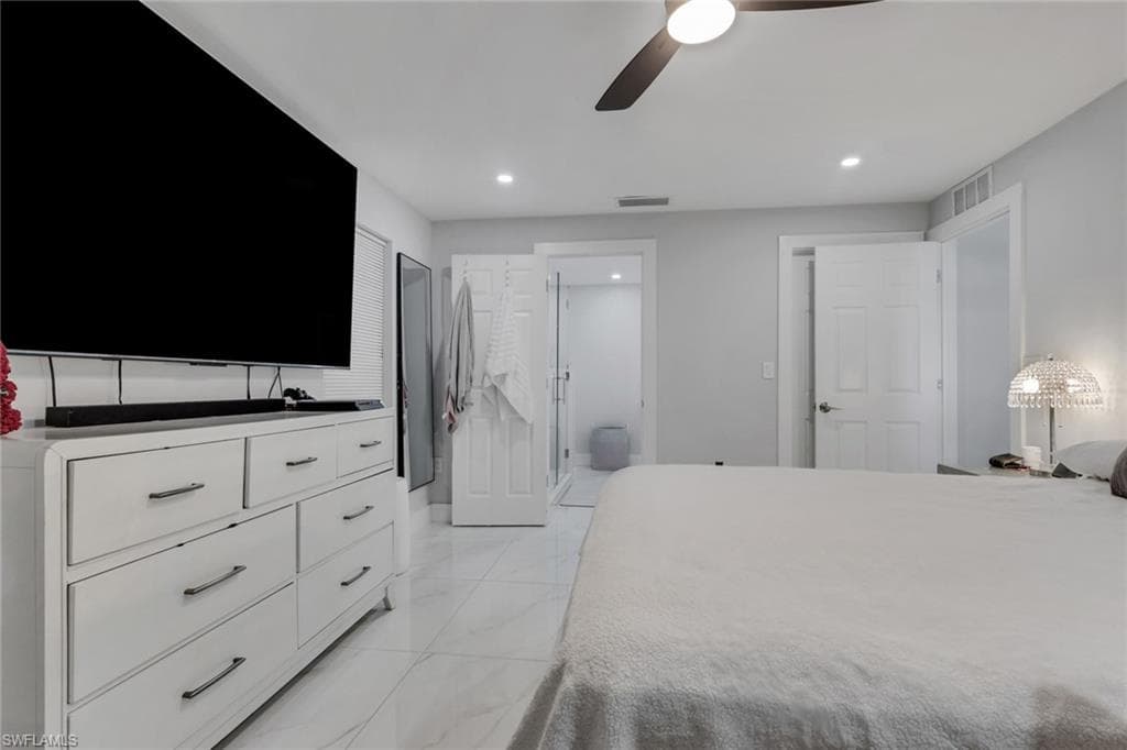 Light-toned interior featuring recessed lighting, a ceiling fan, white paneled doors, and tile flooring