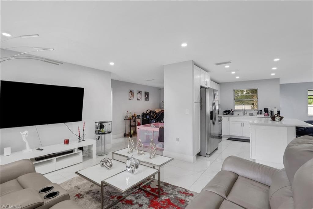 Open-concept living space featuring recessed lighting and tile flooring