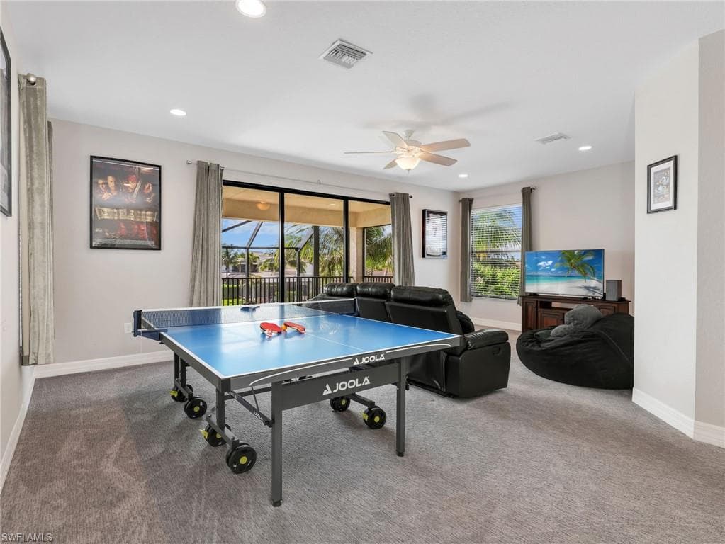 Carpeted recreational room with recessed lighting and a ceiling fan