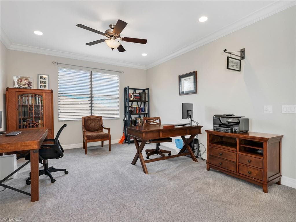 Spacious upstairs loft featuring light gray carpeting, neutral wall color, crown molding, recessed lighting, and a ceiling fan with light fixture