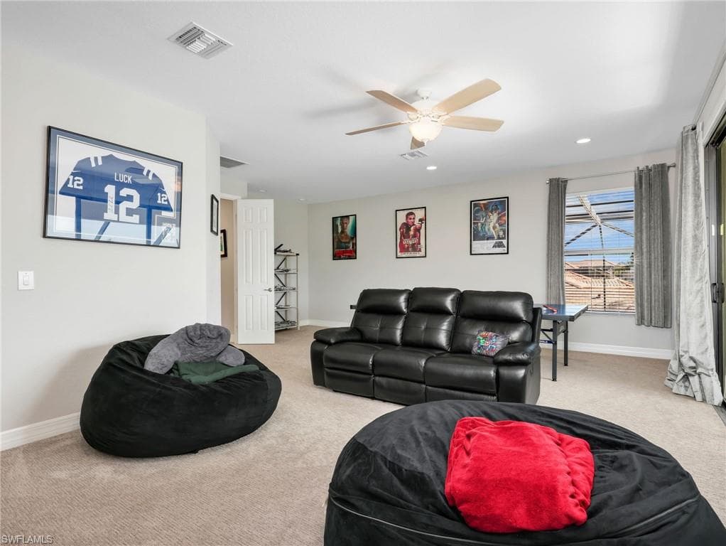 Spacious bonus room featuring neutral carpeting, a ceiling fan with integrated lighting, and recessed lighting