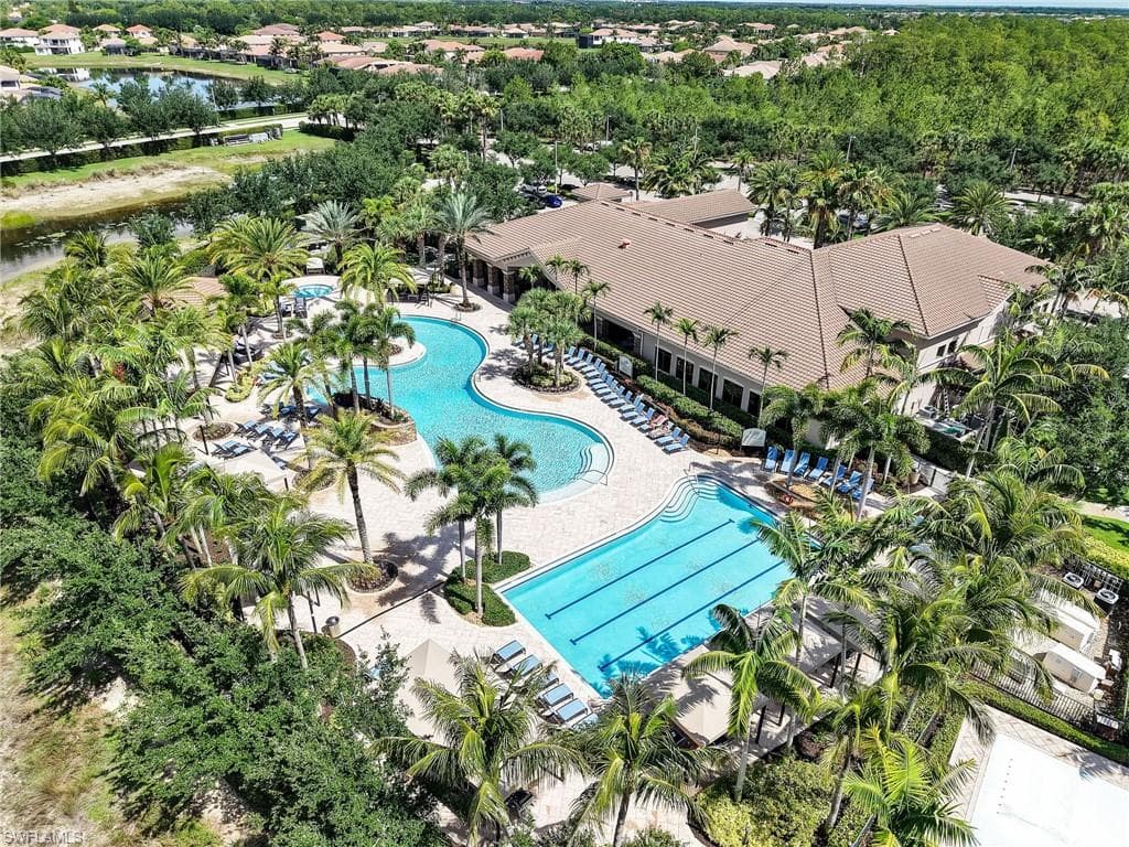 Expansive resort-style swimming pool featuring a curved freeform design and a lap pool