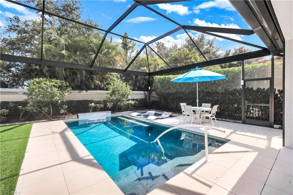 Fabulous lanai with under cover area, large pool, lounge area, electric hurricane screens and built-in kitchen (not shown).