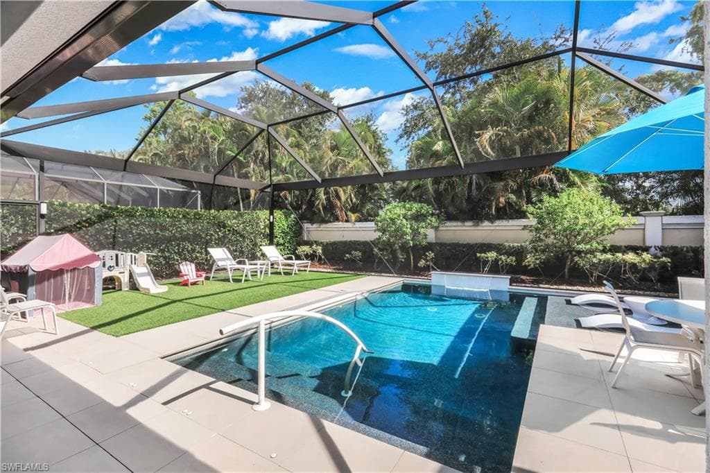 Fabulous lanai with under cover area, large pool, lounge area, electric hurricane screens and built-in kitchen (not shown).