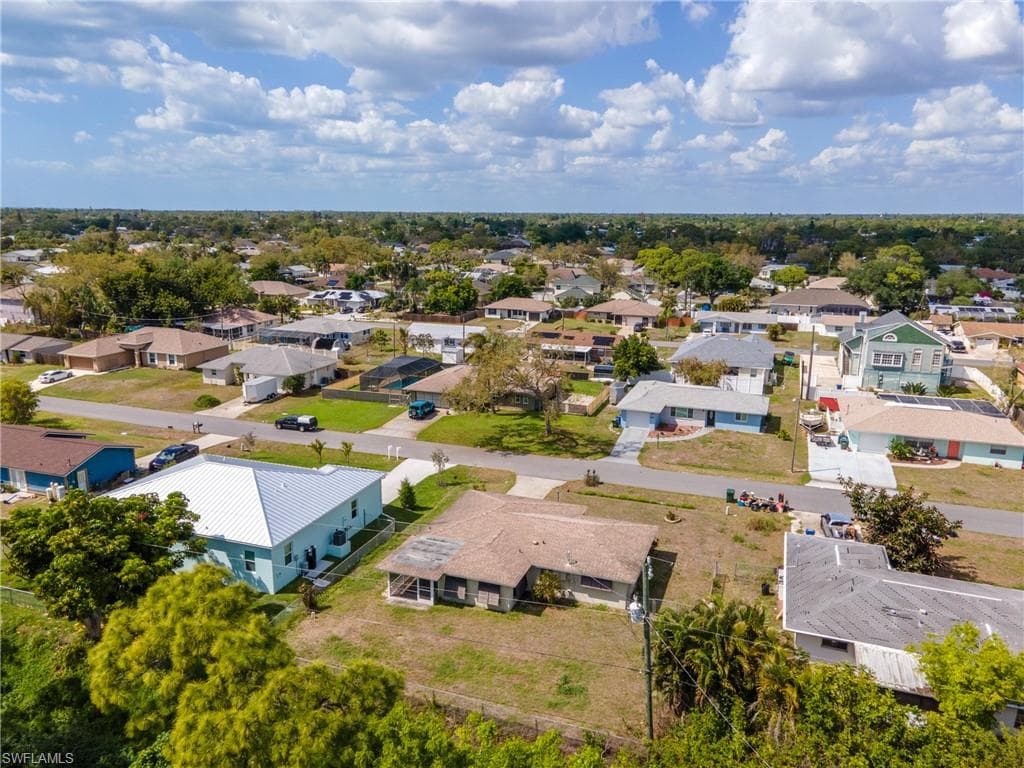 Residential neighborhood with an array of single-story homes, mature trees, and paved roads