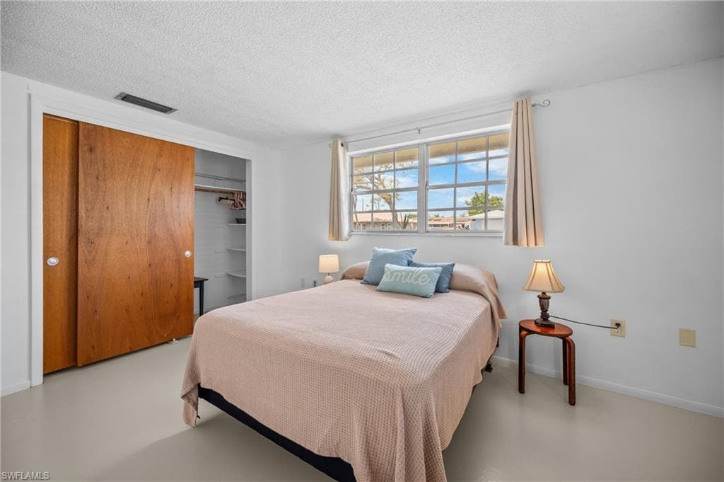 Bedroom featuring light-toned flooring and white walls