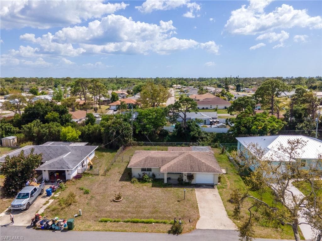 Single-story residence featuring a front yard and an attached garage