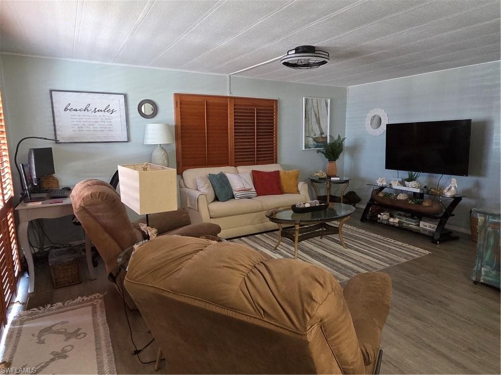Freshly painted interior featuring attractive wood plank-like flooring and plantation shutters