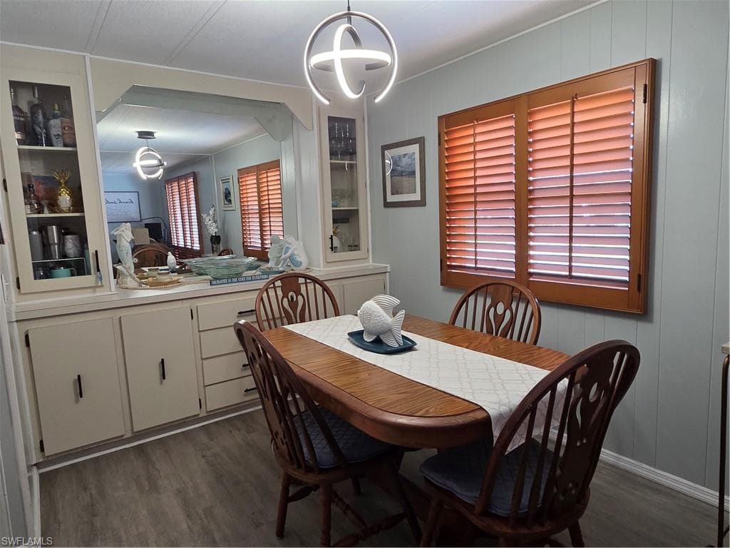 Dining room with large mirror and built-in cabinets.
