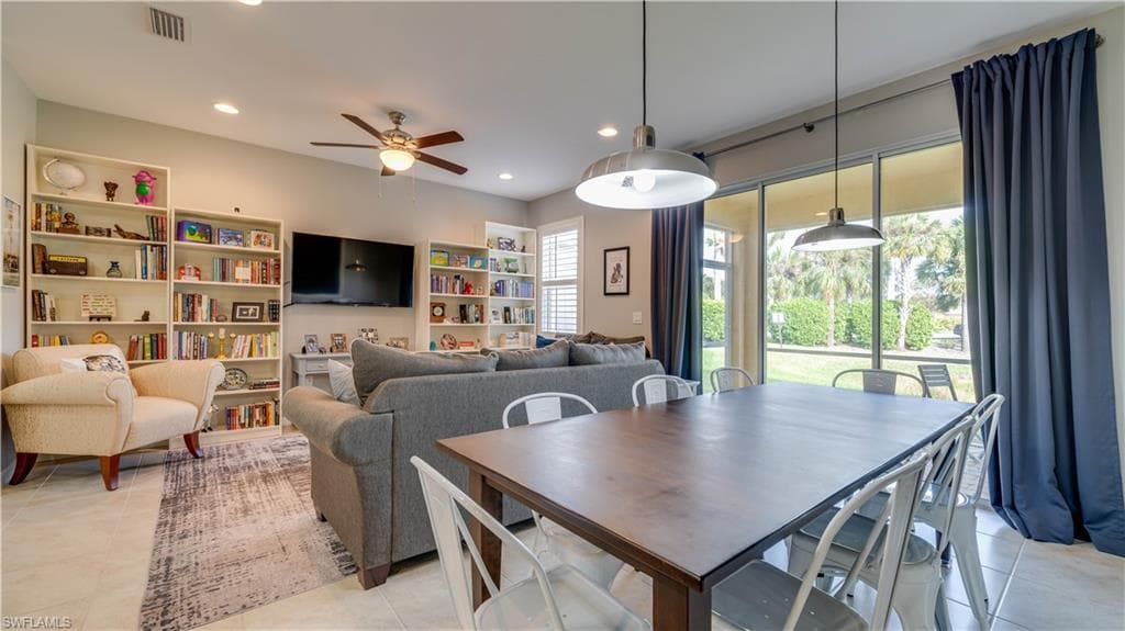 Dining area with ceiling fan and light tile patterned flooring
