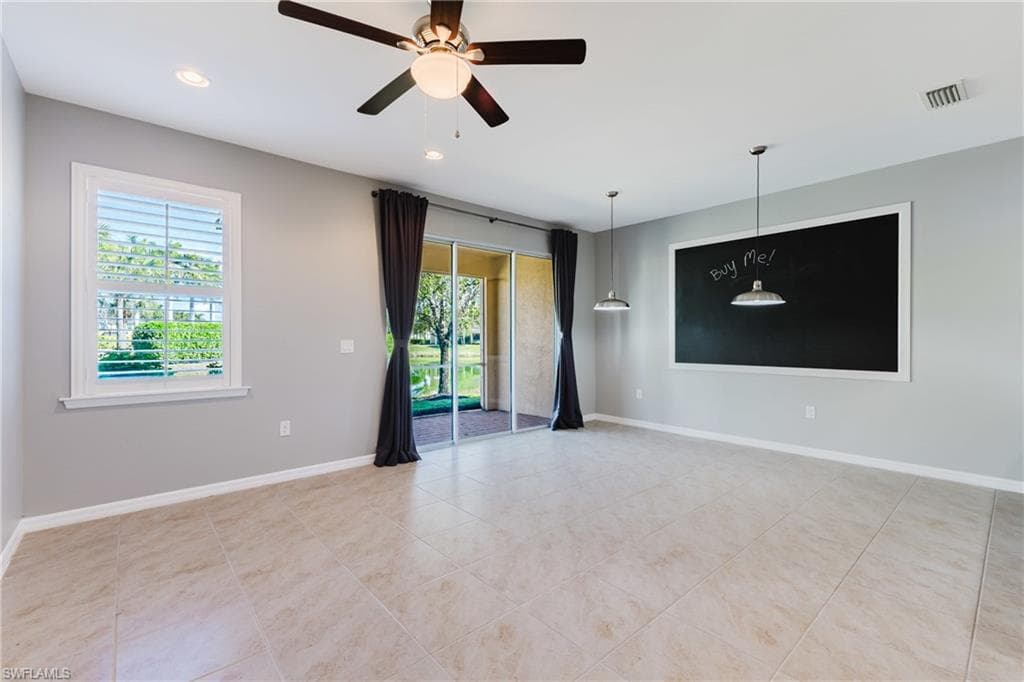 Empty room with ceiling fan, recessed lighting, and light tile patterned floors
