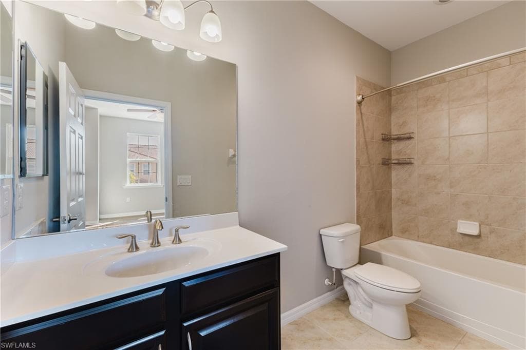 Bathroom with vanity, shower / washtub combination, and light tile patterned flooring