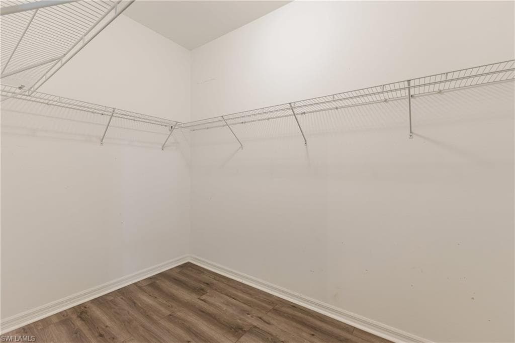 Walk in closet featuring wood finished floors