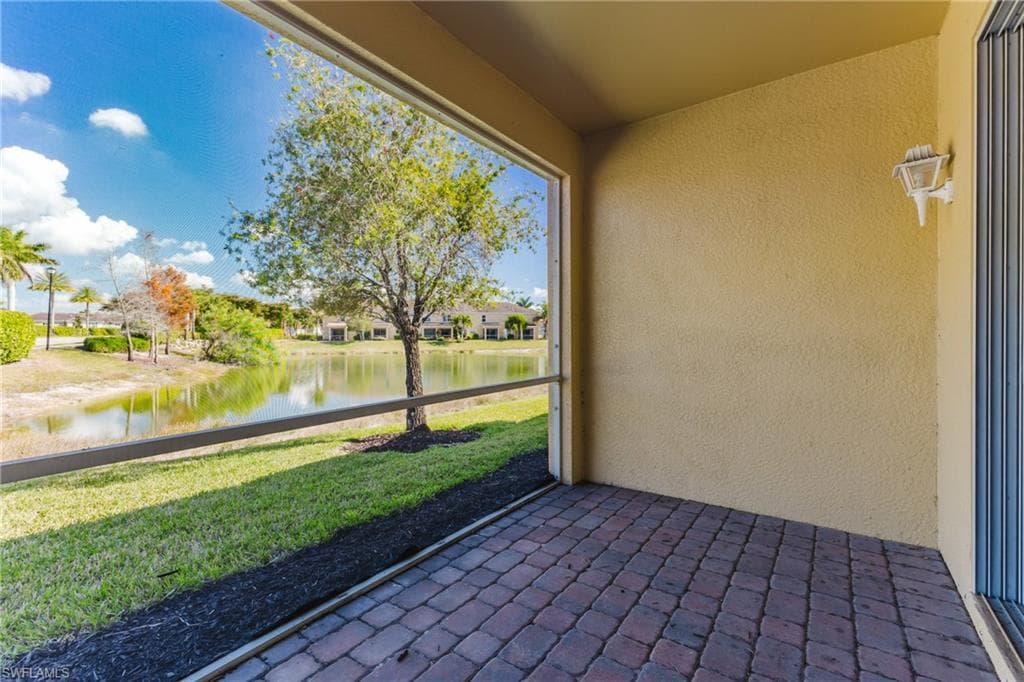 Unfurnished sunroom with a water view and a residential view