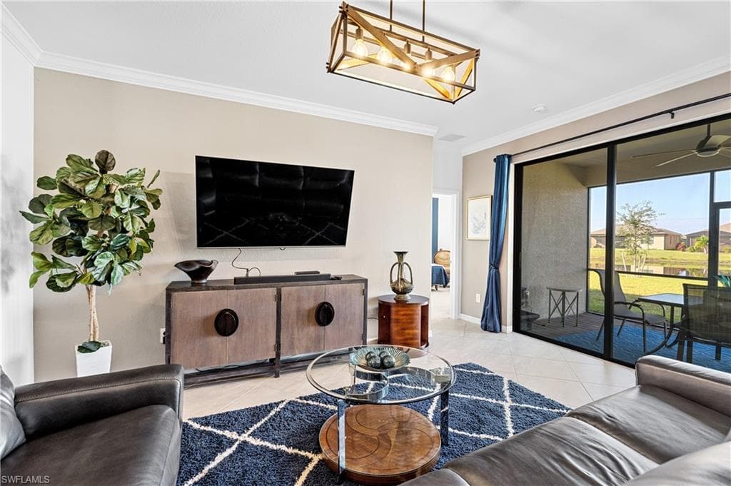 Tiled living area featuring crown molding, a ceiling fan, a sunroom, and a residential view