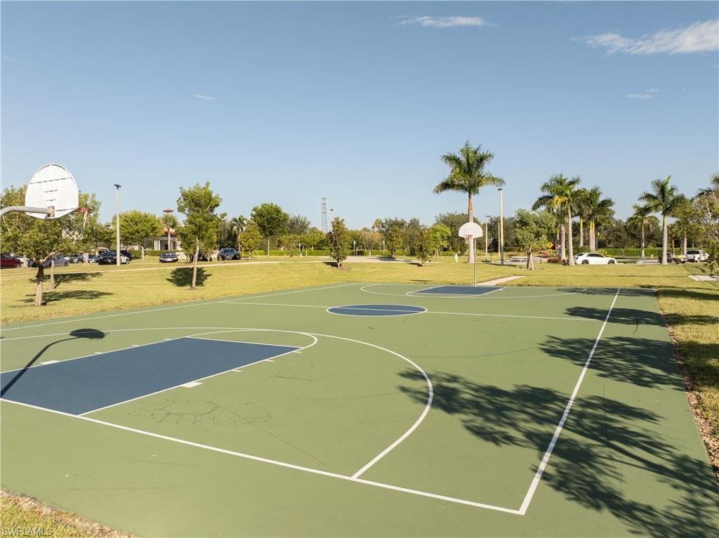 View of sport court featuring a lawn and community basketball court