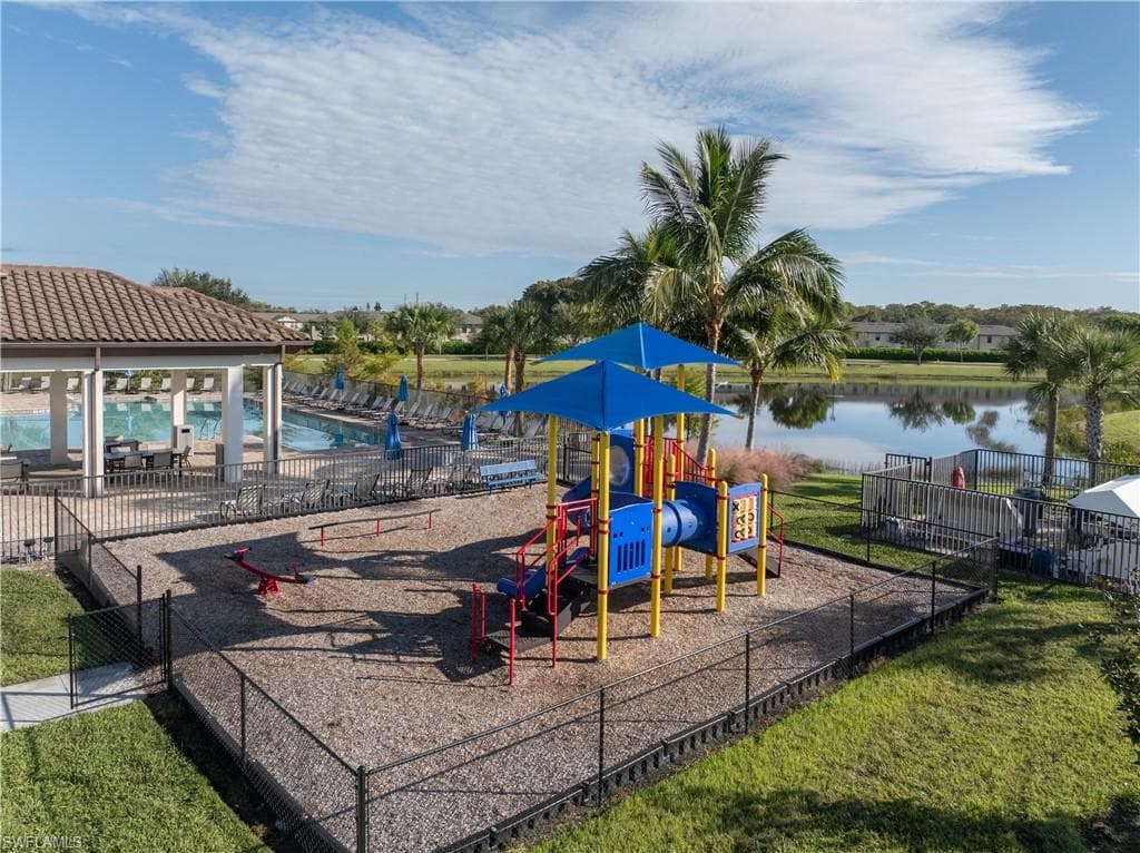 Community jungle gym with a patio, a community pool, and a water view
