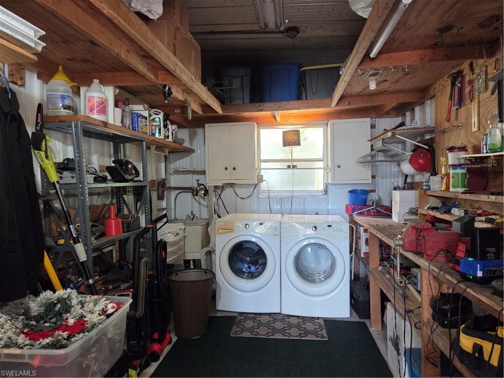 Washer, dryer, and laundry tub are located in the spacious storage shed.