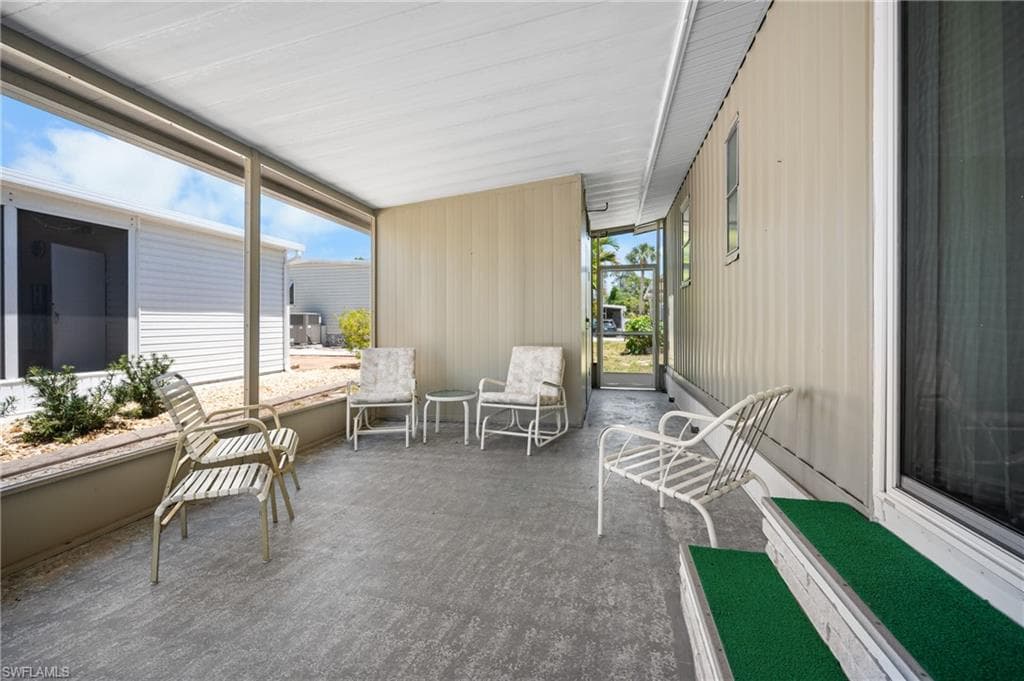 Screened patio featuring a concrete floor, built-in planter with landscaping, and a covered ceiling