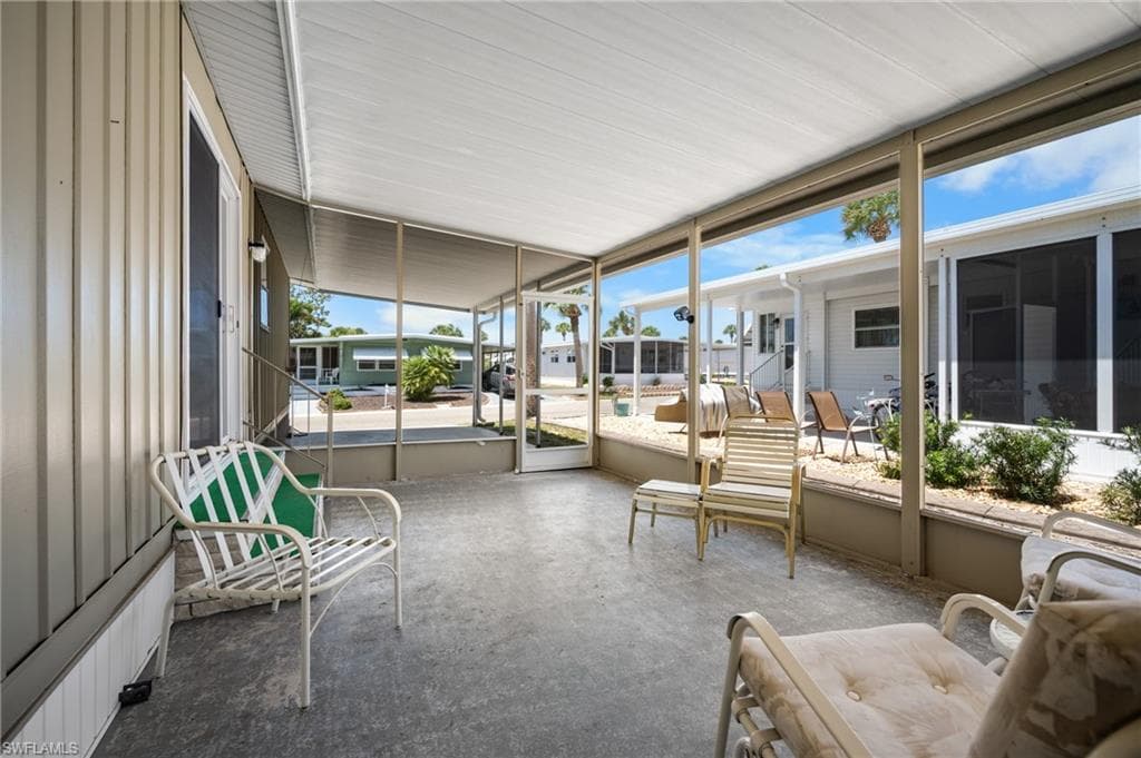 Screened porch featuring a concrete floor and a white panel ceiling
