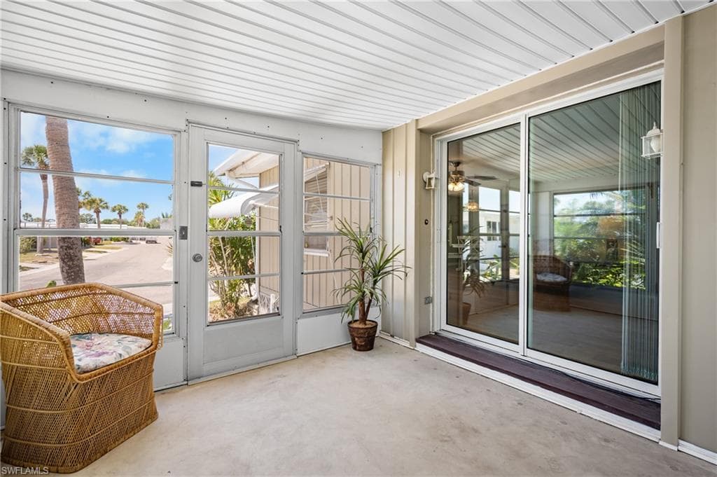 Enclosed patio featuring concrete flooring and a white slatted ceiling